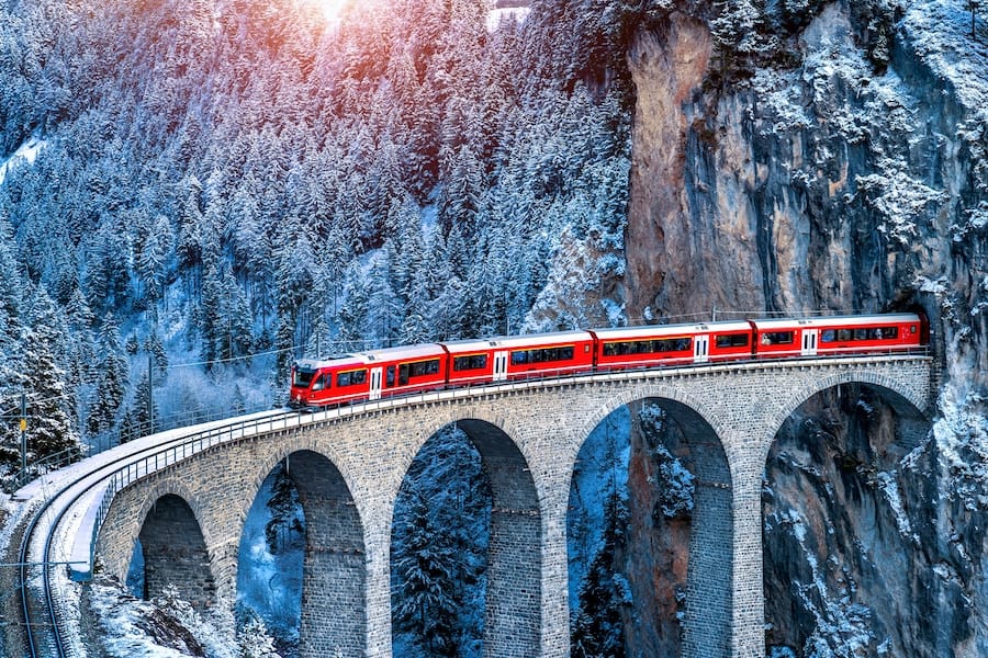 Aerial view of Train passing through famous mountain in Filisur, Switzerland.   train express in Swiss Alps snow winter scenery.
