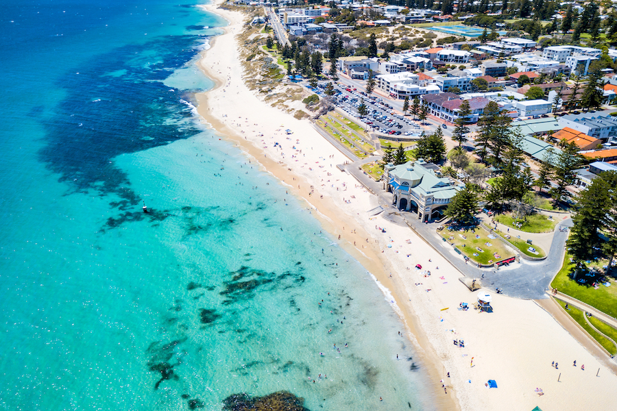 Aerial drone photo of a busy Cottesloe Beach, Perth, Western Australia on a summer afternoon.
