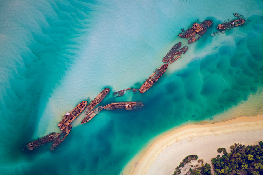 The Tangalooma Wrecks used to be 15 steam driven barges which were deliberately sunk in 1963 along the Moreton Island coastline to form a breakwall so that small boats can anchor in shelter.