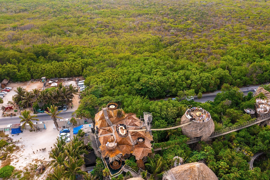 Tulum, Mexico. May 15, 2021. Aerial view of the luxury hotel Azulik in Tulum. Beautiful view of the eco wooden houses in the jungle by the sea shore.