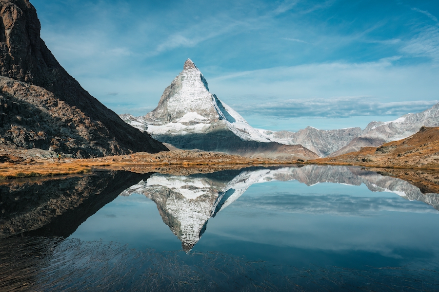 This image has an empty alt attribute; its file name is Riffelsee-Lake-Hike-1.jpg
Beautiful landscape of Matterhorn mountain with blue sky over Riffelsee lake reflection above town of Zermatt at canton of Valais, Switzerland